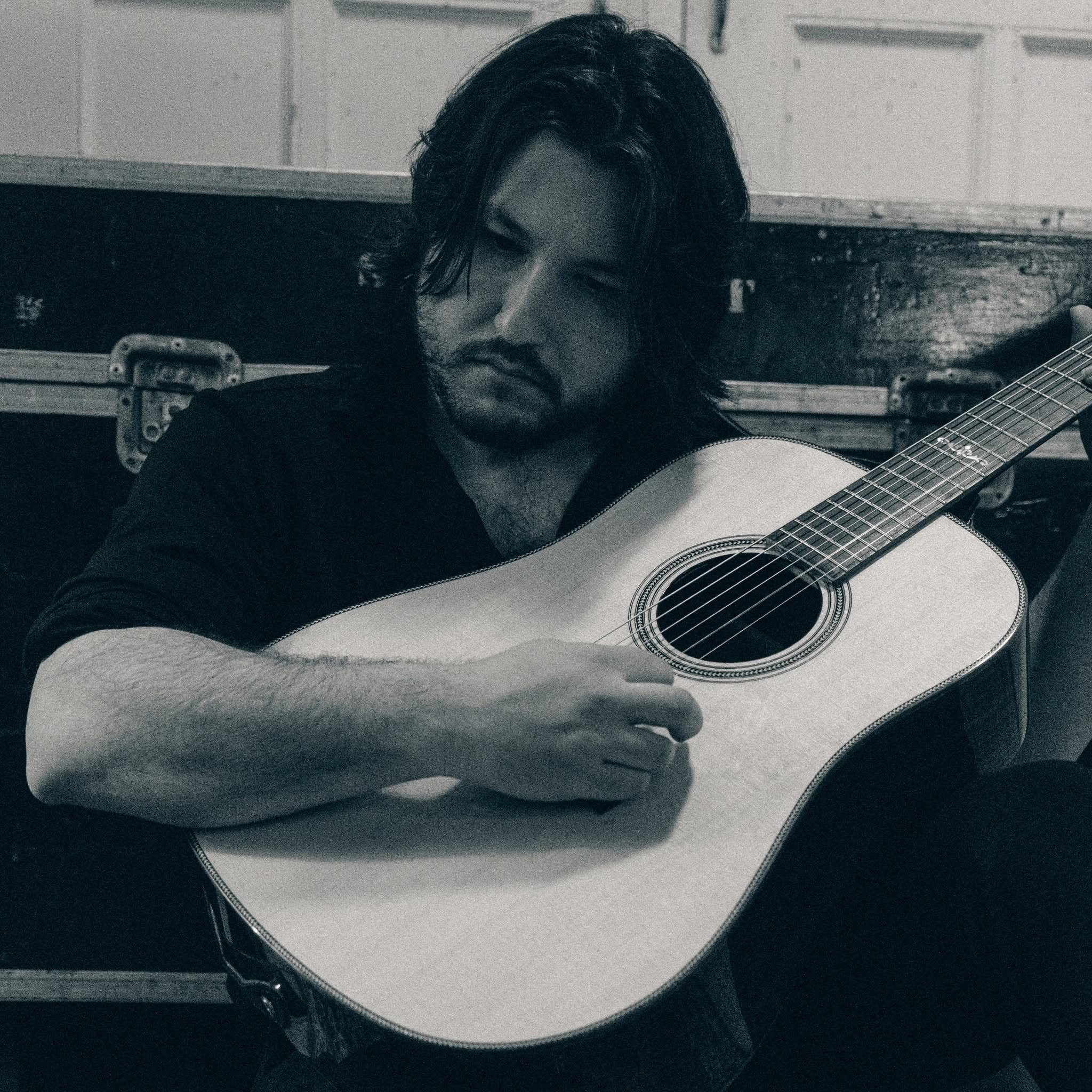 Black-and-white portrait of Sean Donley playing acoustic guitar