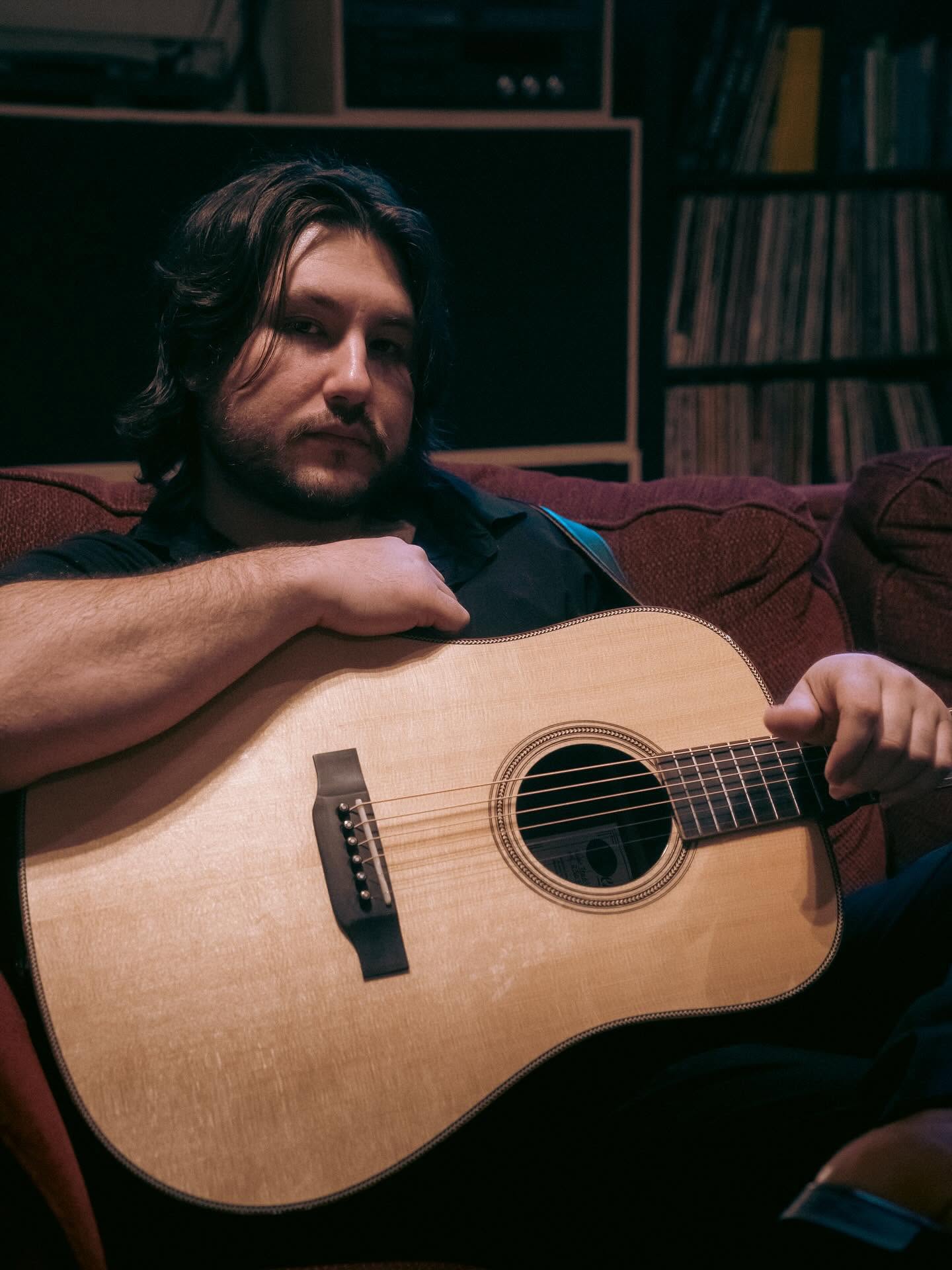 Sean relaxing with his acoustic guitar